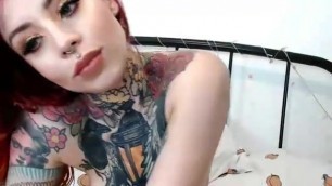gorgeous tattooed redhead proudly shows pierced tits